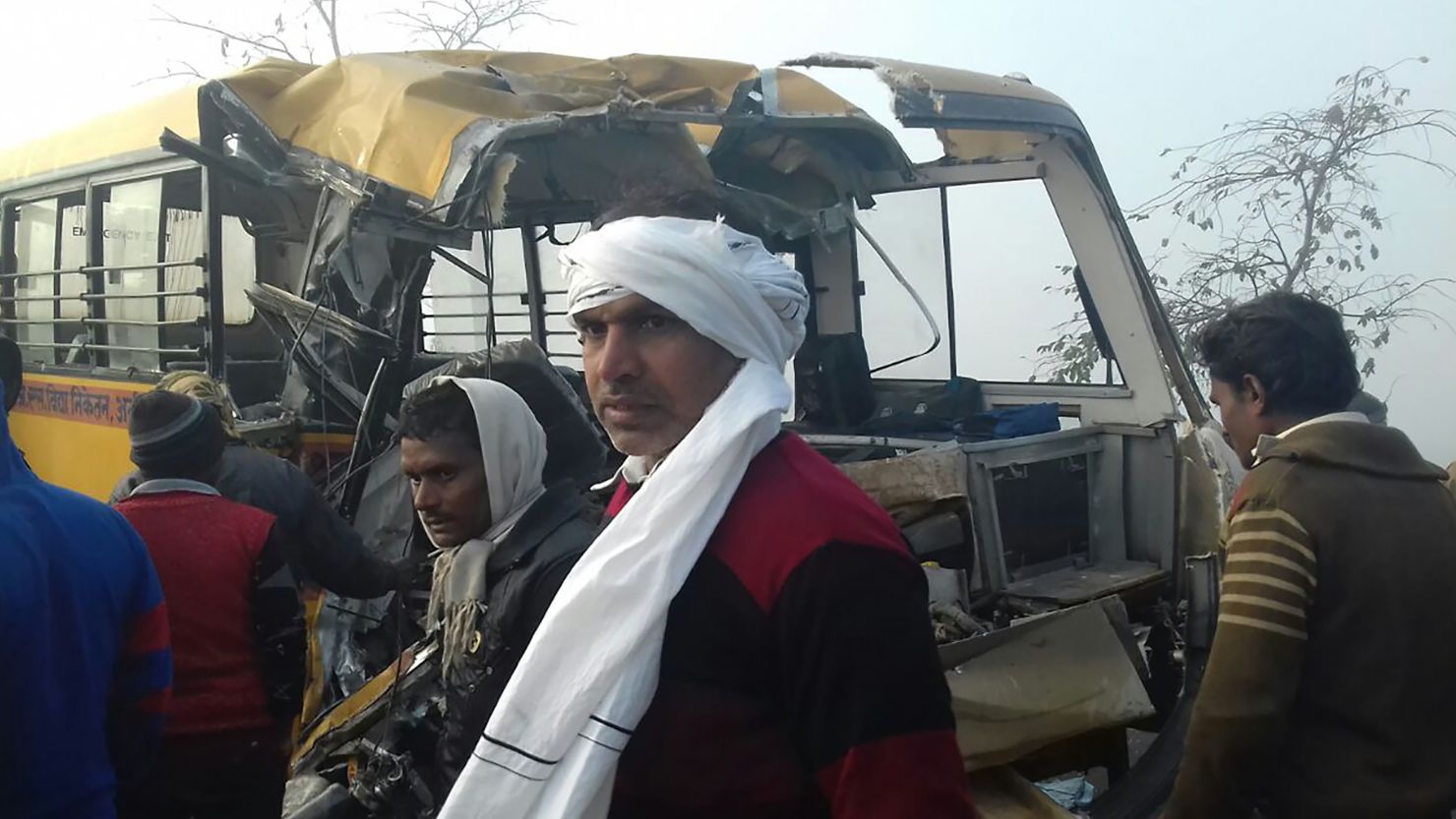 Bystanders gather near the scene of a bus crash in Etah in the state of Uttar Pradesh on January 19, 2017.
