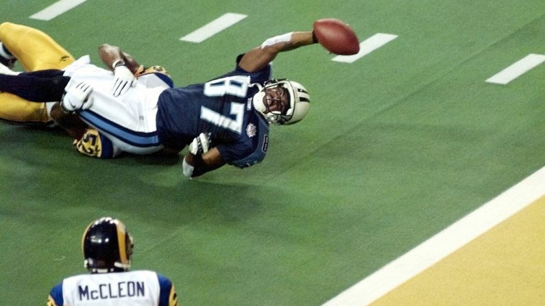 Tennessee Titans wide receiver Kevin Dyson stretches for the end zone but falls short as he is tackled by St. Louis Rams linebacker Mike Jones as time runs out in Super Bowl XXXIV at the Georgia Dome on January 30, 2000. The Rams defeated the Tennessee Titans, 23-16.