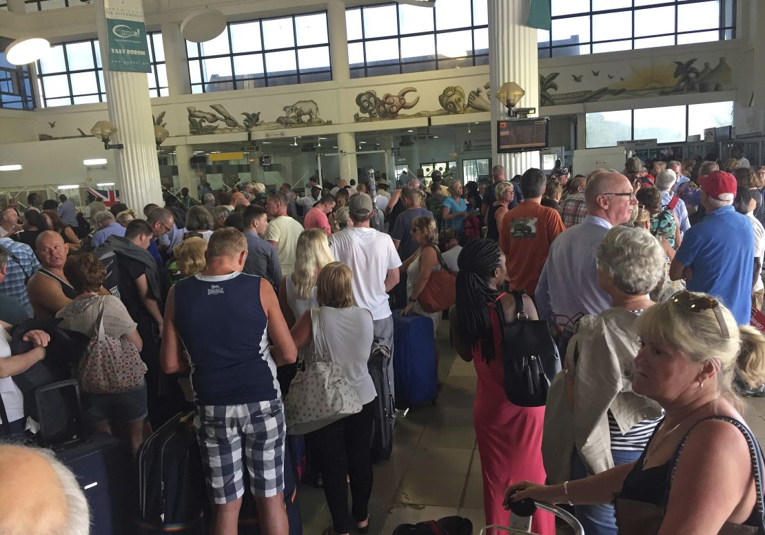 Tourists gather at the Banjul airport Wednesday as tour operators send in extra flights for evacuation.