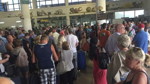 Tourists gather at the Banjul airport Wednesday as tour operators send in extra flights for evacuation.