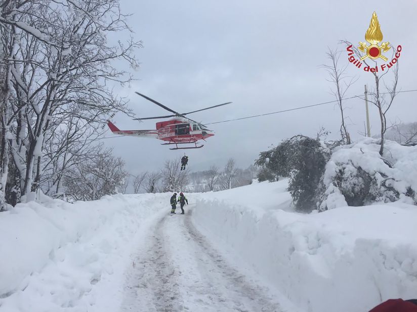 Rescuers are dropped by helicopter near the site of the avalanche. Weather conditions in the region made it difficult to access the area by road.