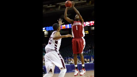 Alabama's Mykal Riley makes a shot over Charles Rhodes of Mississippi State during the SEC Men's Basketball Tournament in March 2008. Riley's last-second 3-point shot would force the game into overtime, keeping many fans inside the stadium as a tornado churned toward downtown Atlanta.