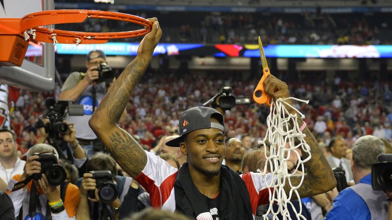 An injured Kevin Ware of the Louisville Cardinals cuts the net after his team defeated Michigan, 82-76, in the NCAA men's basketball championship game at the Georgia Dome on April 8, 2013.