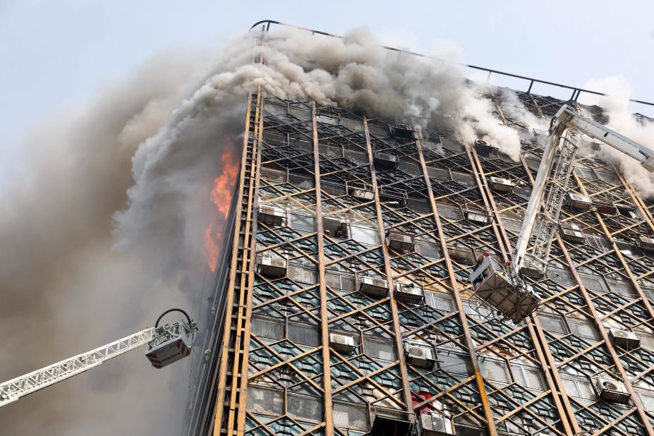 Firefighters work to control the blaze. Fars agency cited Mojtaba Doroodian, head of the shirt makers' union, as saying that the fire was the result of a leak in a small gas cylinder on the 10th floor, which caused an explosion when a merchant turned on the lights in his store. Tehran Fire Department spokesman Jalal Maleki said the cause of the building fire and collapse is being investigated.