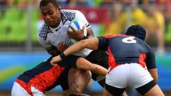 TOPSHOT - Fiji's Leone Nakarawa is tackled in the mens rugby sevens semi-final match between Fiji and Japan during the Rio 2016 Olympic Games at Deodoro Stadium in Rio de Janeiro on August 11, 2016. / AFP / Pascal GUYOT        (Photo credit should read PASCAL GUYOT/AFP/Getty Images)