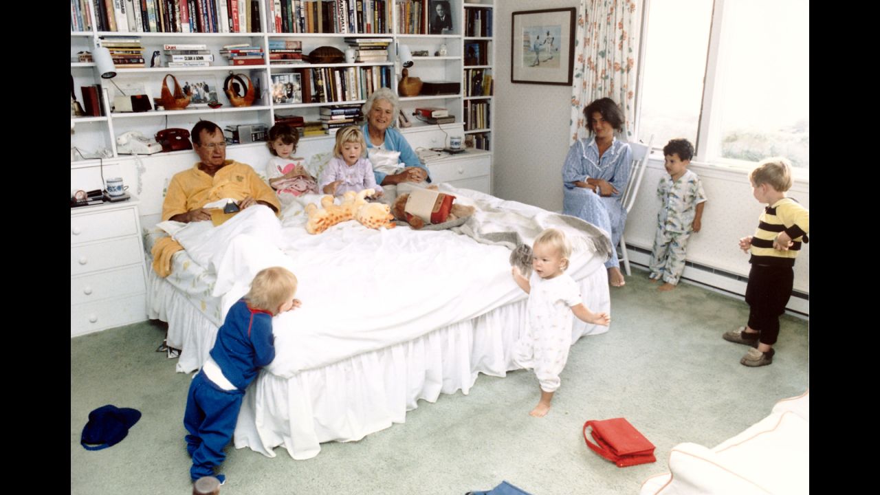 Bush with her husband in a bedroom with their grandchildren.