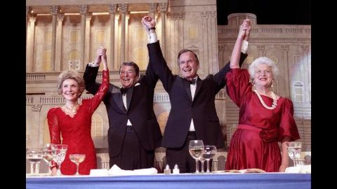President Reagan and Vice President Bush, accompanied by their wives, join hands after Reagan endorsed Bush's run for the presidency during a dinner in Washington on May 11, 1988.