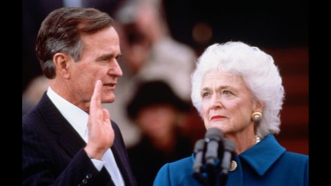 Barbara Bush looks on as her husband takes the oath of office at his inauguration on January 20, 1989.