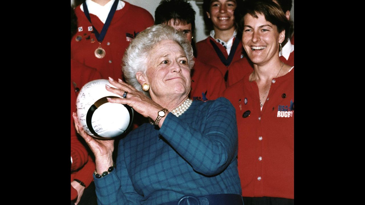 Bush prepares to throw a rugby ball after receiving it from Mary Sullivan -- captain of the US women's rugby team -- on February 7, 1992. The US team, which won the World Cup, received the Team Spirit Award from Bush.