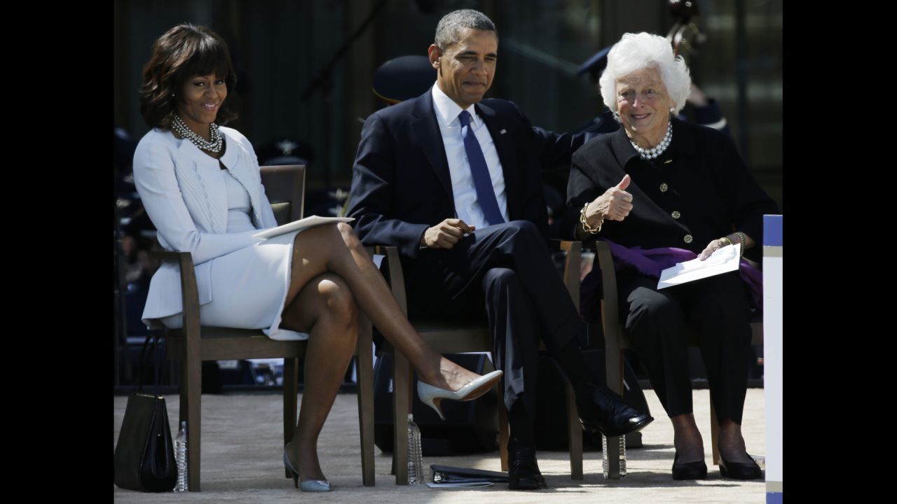 The former first lady gives the thumbs-up to guests during a dedication of the George W. Bush Presidential Center on April 25, 2013. She is seated next to US President Barack Obama and first lady Michelle Obama.