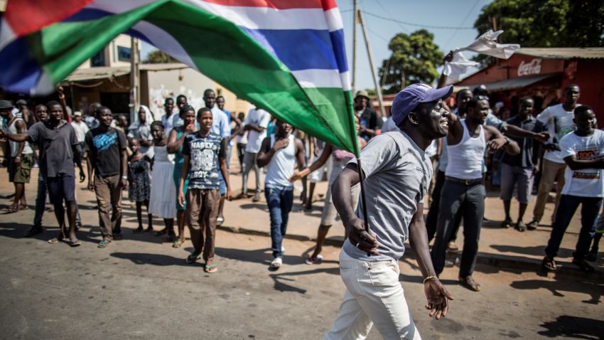 A man waves a Gambian flag while he celebrates the victory of Gambia's opposition candidate Adama Barrow during the Presidential Elections on December 2, 2016, in Serekunda, Banjul.
The impoverished west African nation of Gambia is set for a rare handover of power after long-serving President Yahya Jammeh suffered a shock defeat at the polls. Rights bodies and media watchdogs accuse Jammeh of cultivating a "pervasive climate of fear" during his 22 years in office and of crushing dissent against his regime.
 / AFP / MARCO LONGARI        (Photo credit should read MARCO LONGARI/AFP/Getty Images)