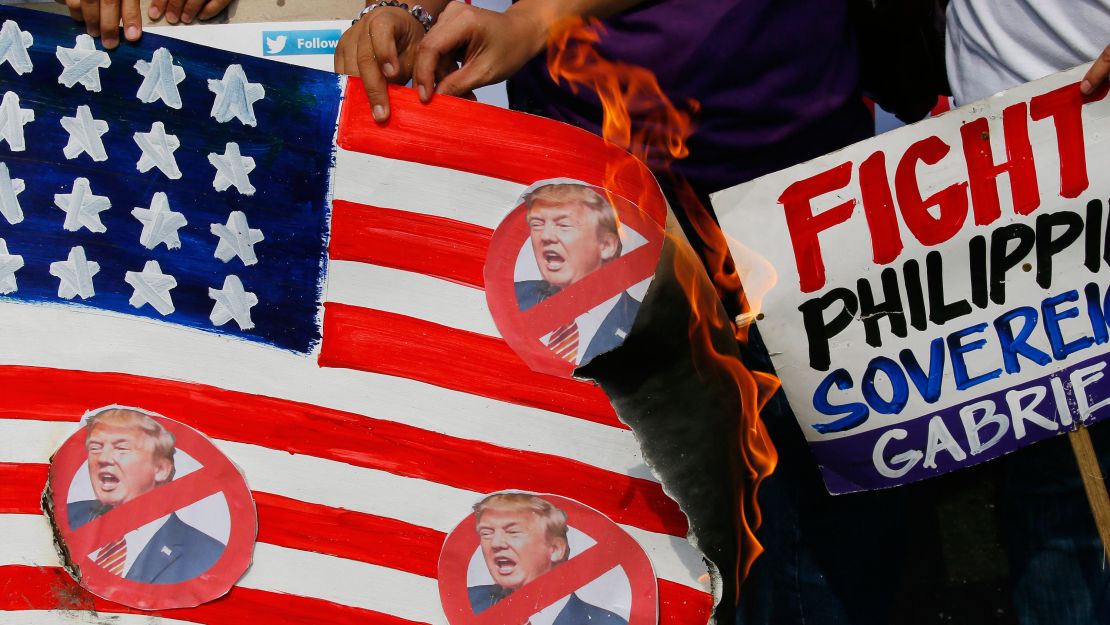 Protesters burn a mock US flag during a rally outside the US Embassy in Manila on Friday.