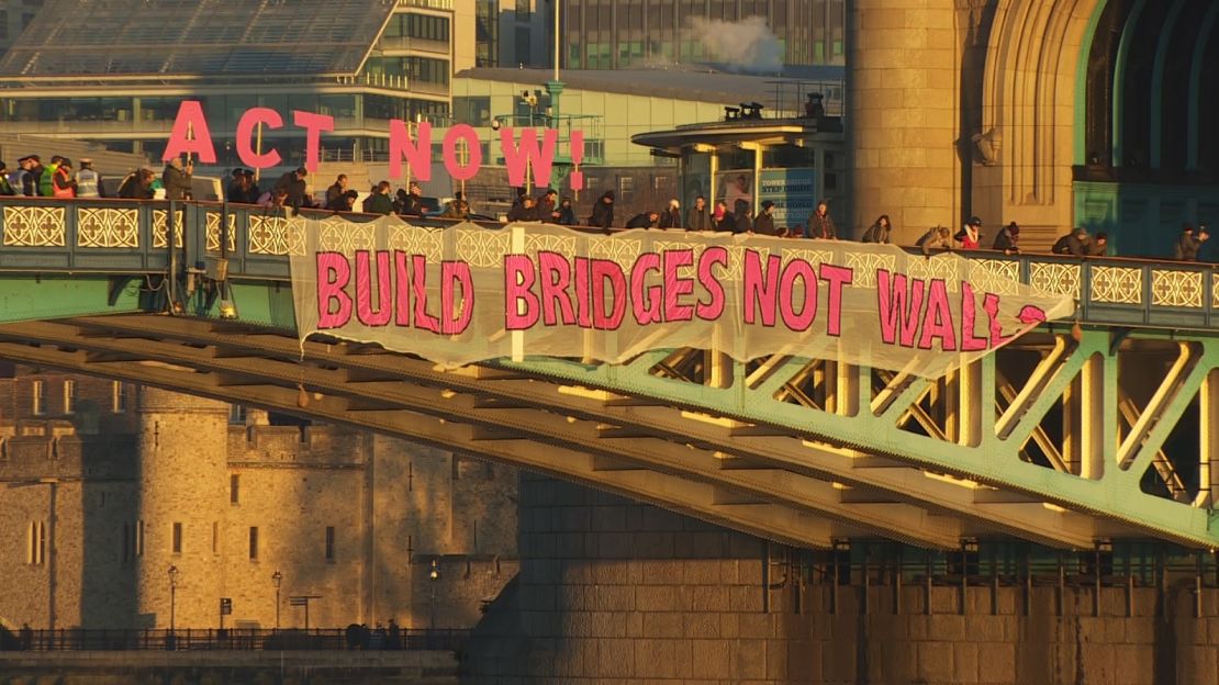 A "Bridges Not Walls" banner hangs from London's Tower Bridge on Friday.