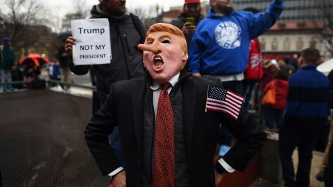 Demonstrators protest against US President-elect Donald Trump before his inauguration on January 20, 2017, in Washington, DC. 