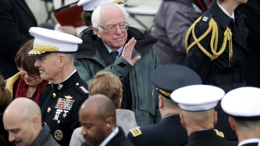 Sen. Bernie Sanders waves to the crowd from the West Front of the Capitol before the ceremony.