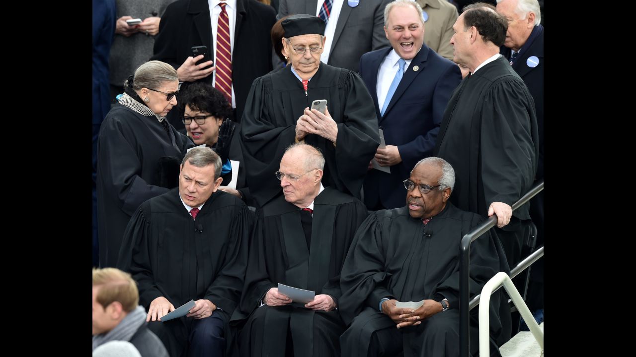 Supreme Court justices await the ceremony. Front from left: Chief Justice John Roberts and Justices Anthony Kennedy and Clarence Thomas. Back from left: Justices  Ruth Bader Ginsburg, Sonia Sotomayor, Stephen Breyer and Samuel Alito.