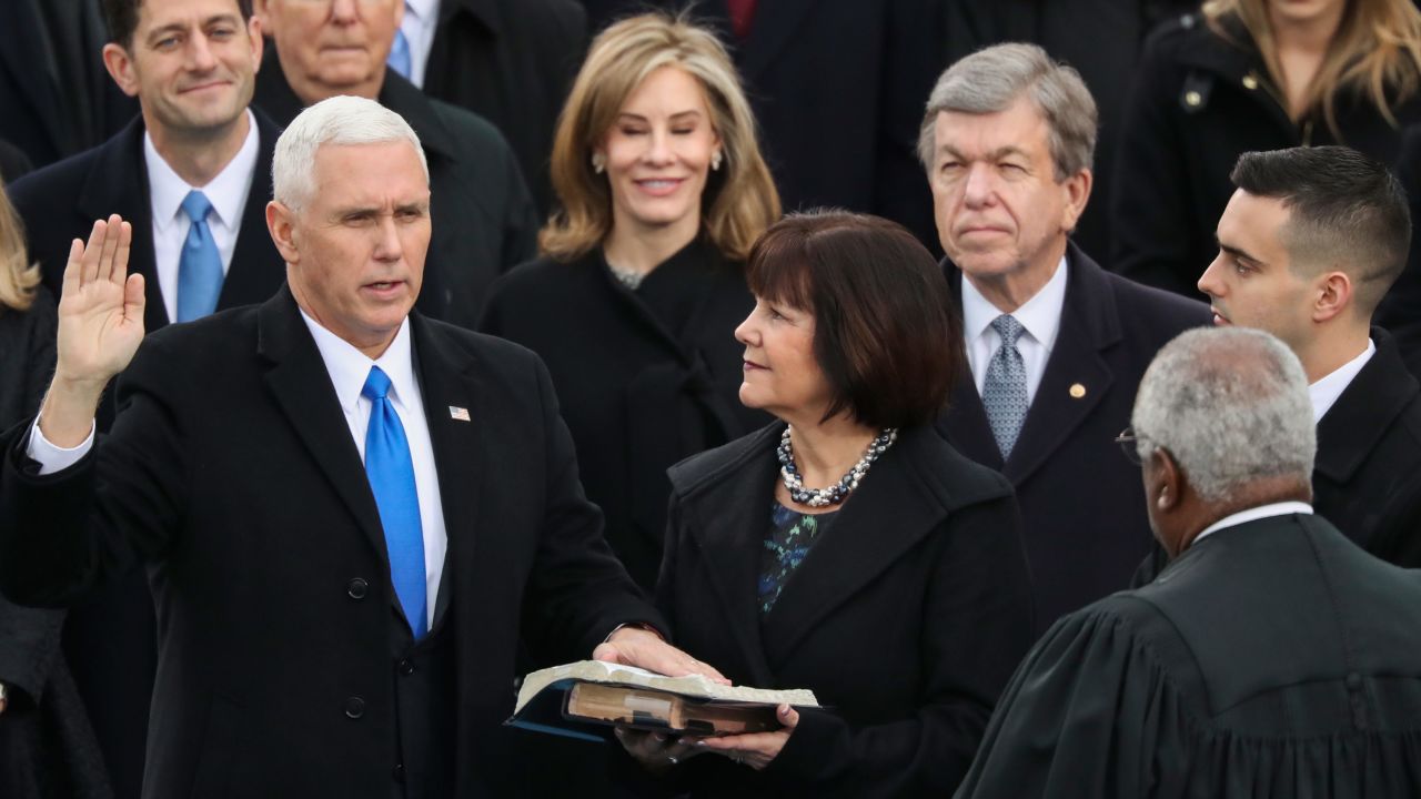 Vice President Mike Pence is sworn in by Justice Clarence Thomas as Pence's wife, Karen, holds the bible.