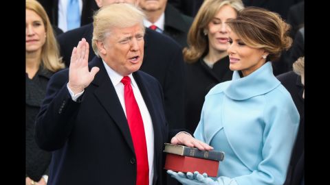 Trump is sworn in as President with his wife, Melania, at his side.