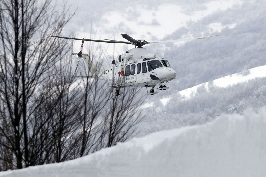 A rescue helicopter approaches the avalanche area in Rigopiano, central Italy, Friday.