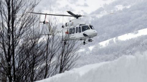 A rescue helicopter approaches the avalanche area in Rigopiano, central Italy, Friday.