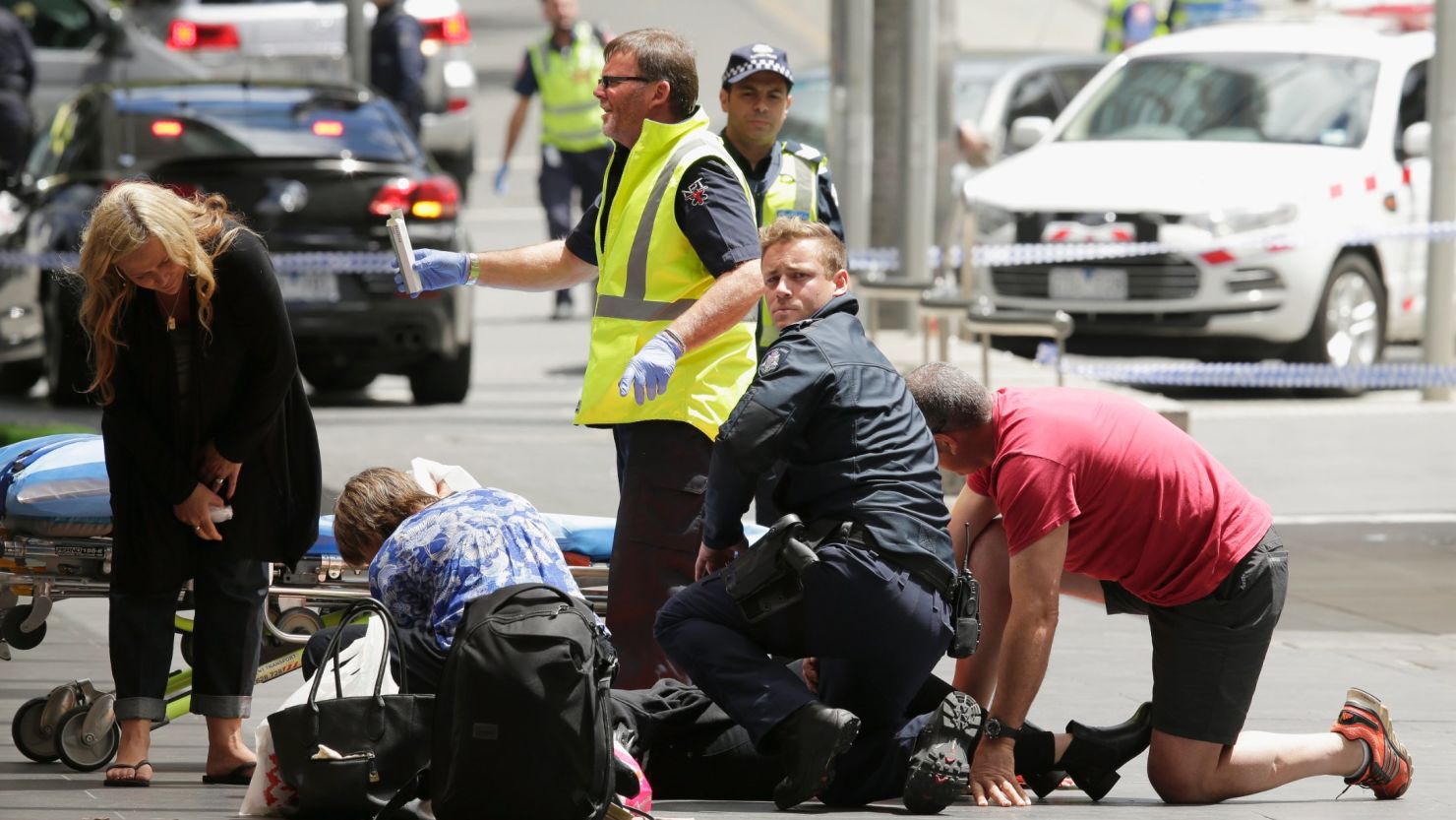 Members of the public receive medical treatment after a car driven by James Gargasoulas crashed into crowds in Melbourne, Australia, January 20, 2017. 