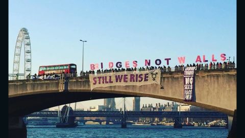 Protesters hold letters spelling out "Bridges Not Walls" on London's Waterloo Bridge on Friday morning.