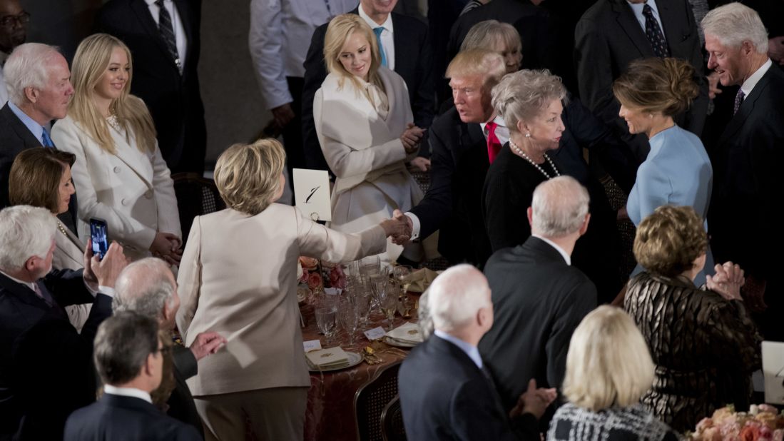 Newly sworn in President Trump shakes hands with Hillary Clinton.