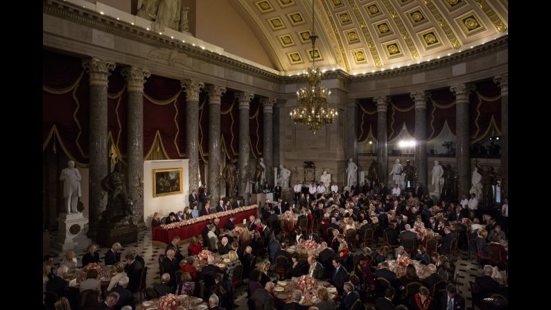 Dignitaries bow their heads in prayer during the inaugural luncheon.