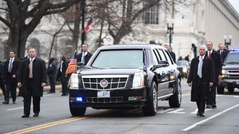 Secret Service members surround the presidential limousine as it drives up Pennsylvania Avenue during the Presidential Inaugural Parade on Friday, January 20, in Washington.