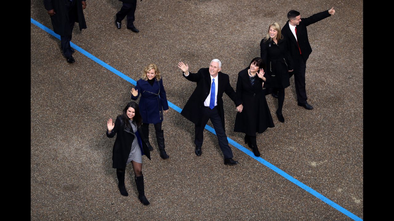 Vice President Mike Pence, center, waves to supporters as he walks with his family during the Presidential Inaugural Parade.