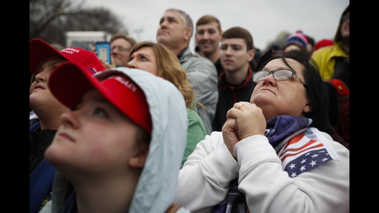 Trump supporters listen during the inauguration in Washington on Friday, January 20.