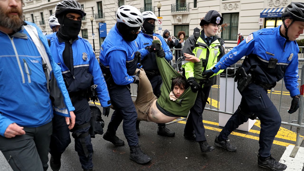 A protester is carried off by authorities prior to the start of Donald Trump's presidential inauguration in Washington on Friday, January 20.