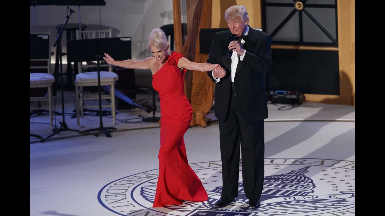 Donald Trump holds the hand of Kellyanne Conway, his senior adviser, as she takes a bow during a VIP reception and dinner with donors in Washington on Thursday, January 19, the night before Trump's presidential inauguration.
