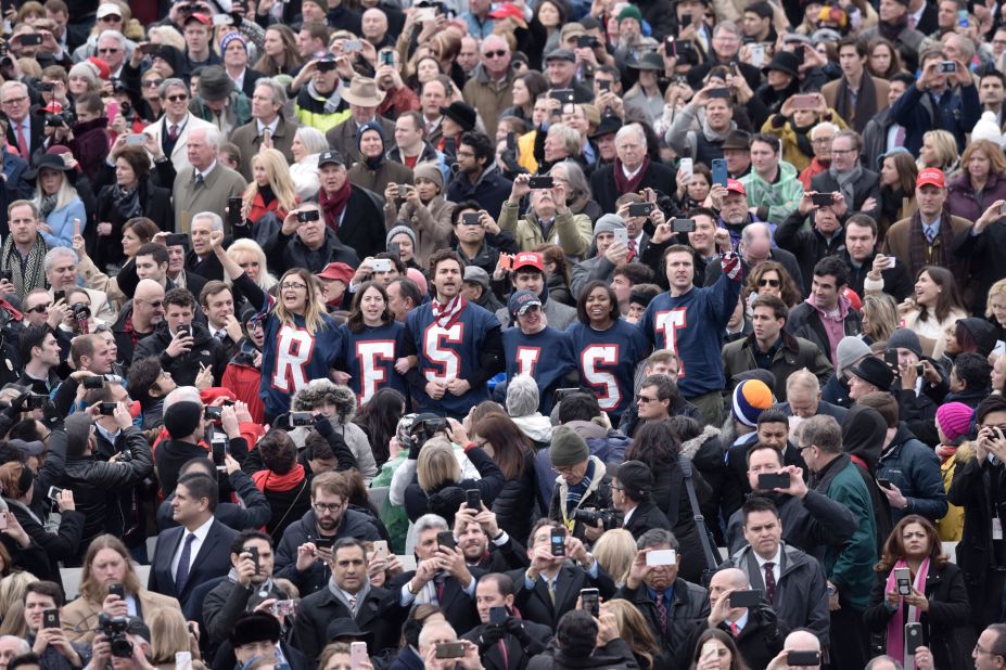 Members of the public chant slogans and display T-shirts reading "resist" during a protest at the beginning of Donald Trump's swearing-in ceremony as 45th President. 
