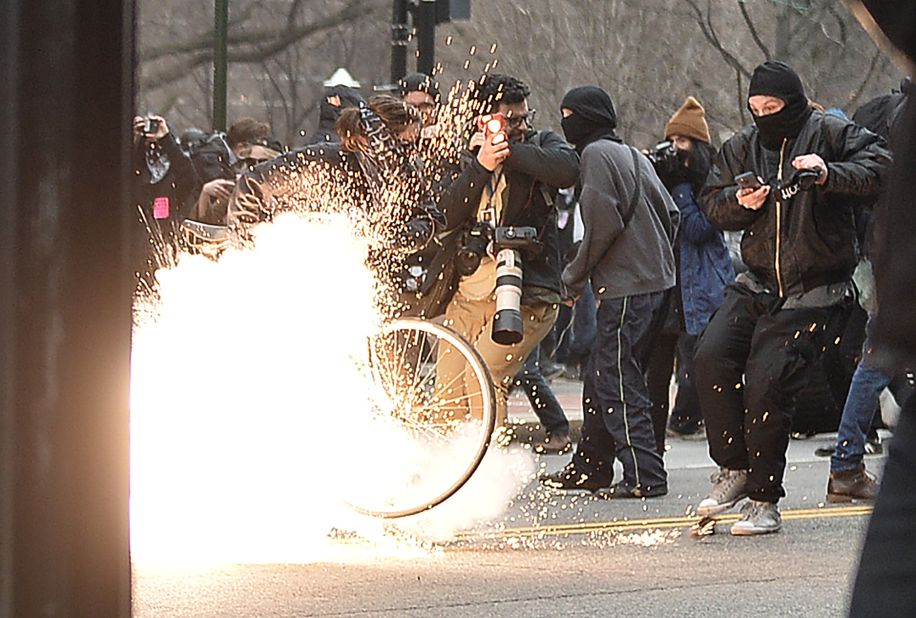 A police flash-bang grenade explodes during a clash with protesters. "Pepper spray and other control devices were used to control the criminal actors and protect persons and property," police said.