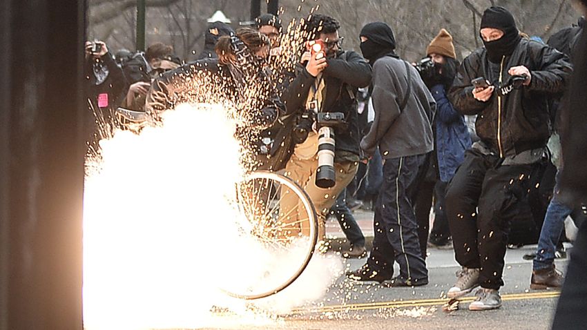 TOPSHOT - A police flash-bang grenade explodes as they clash with protesters after the inauguration of US President Donald Trump on January 20, 2017 in Washington, DC. / AFP / Andrew CABALLERO-REYNOLDS        (Photo credit should read ANDREW CABALLERO-REYNOLDS/AFP/Getty Images)