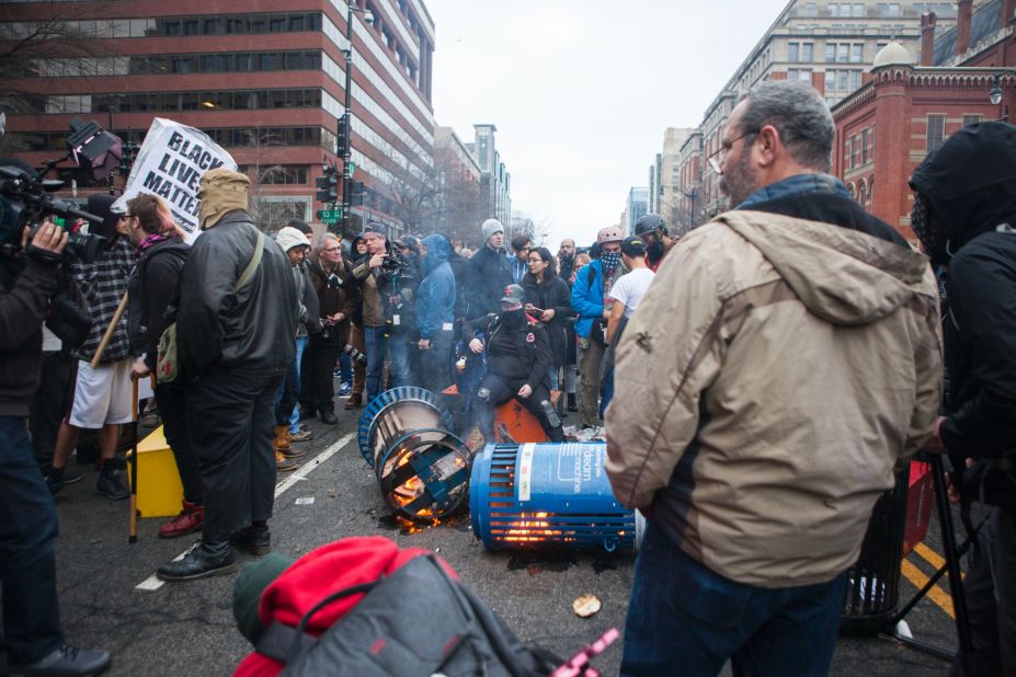 Protesters set trash cans ablaze. 