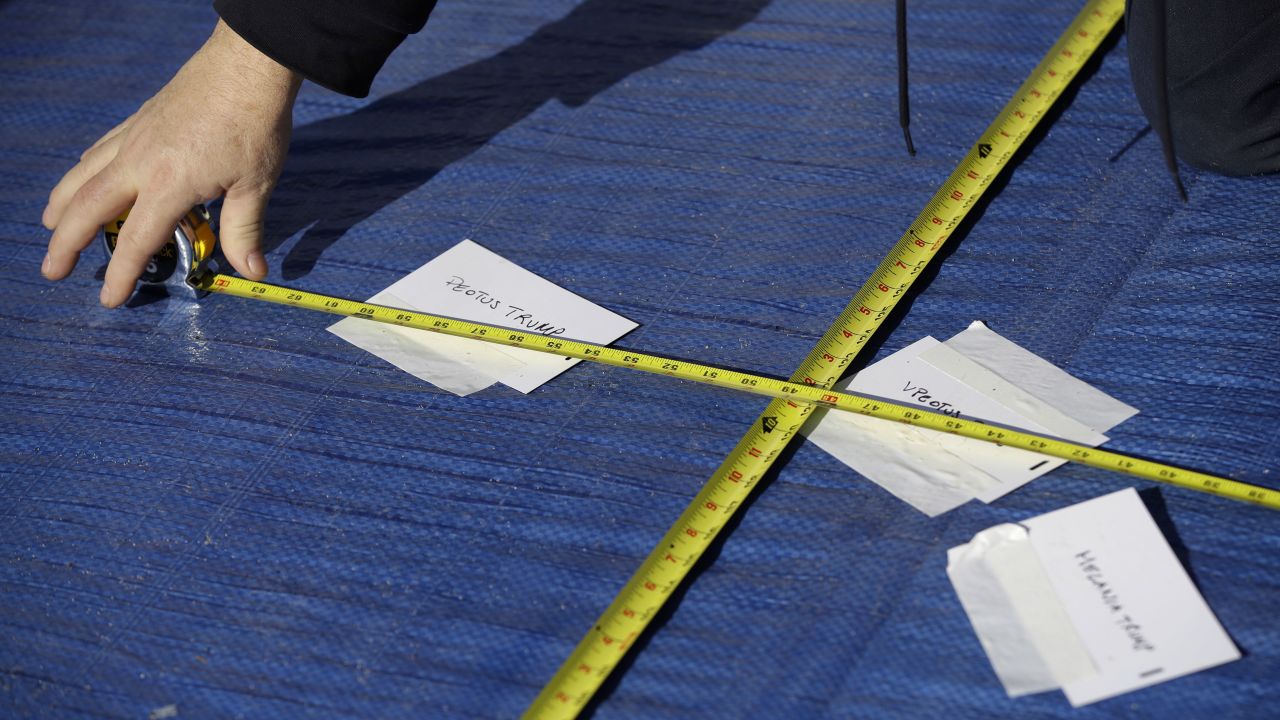 A worker measures Donald Trump's onstage standing position for his presidential inauguration ceremony.