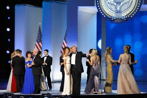 President Donald Trump, first lady Melania Trump, Vice President Mike Pence and his wife Karen dance with their families on stage at the Freedom Ball. 