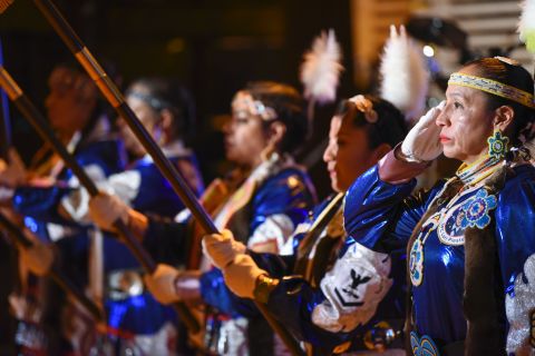 Mitchelene BigMan, right, president and founder of the Native American Women Warriors, salutes as the group performs the Presentation of Colors at the Native Nations Inaugural Ball at the Smithsonian's National Museum of the American Indian.
