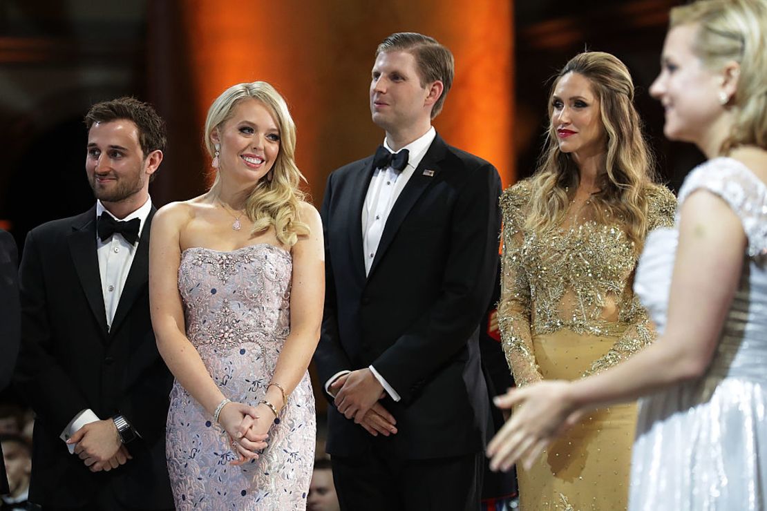 Tiffany Trump and her guest Ross Mechanic, and Eric Trump and his wife Lara Yunaska watch as US President Trump cuts a cake. 