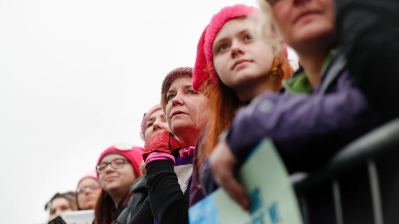 Women gather on a barricade on the National Mall.