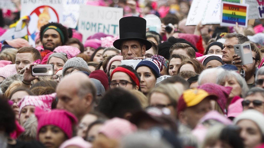 A man dressed as Abraham Lincoln stands with protesters.