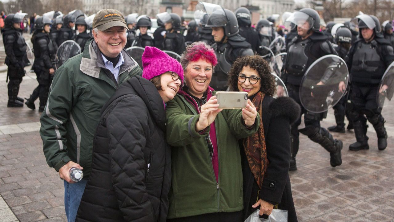 Protesters take a selfie on the grounds of the US Capitol.