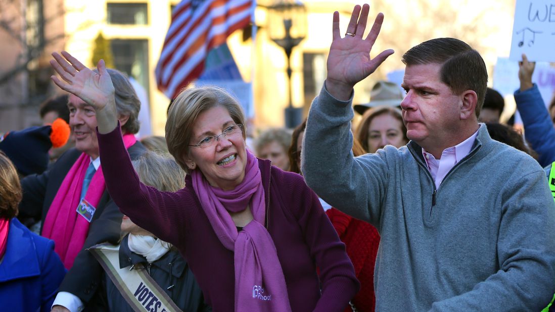 Thousands of people filled Boston Common for the Boston Women's March for America on Saturday, January 21, 2017. Sen. Elizabeth Warren and Boston Mayor Marty Walsh wave to the crowd as they march down Commonwealth Avenue. 