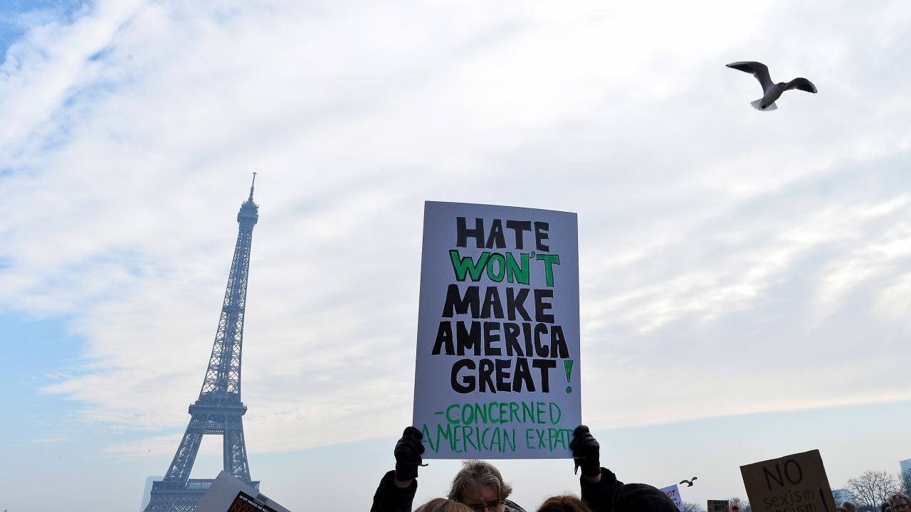Protesters hold up anti-Trump signs as more than 2,000 people protest during the Women's March on the Trocadero in front of the Eiffel Tower in Paris, France on January 21, 2017. 