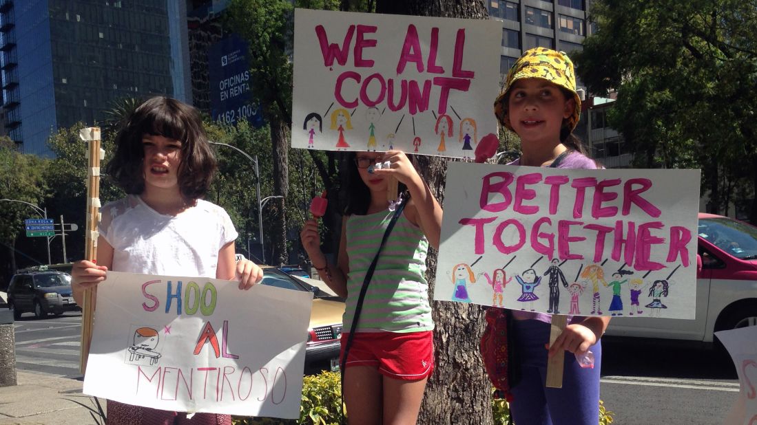 Young girls joined the rally in Mexico City, where marchers formed a human wall along the capital's central thoroughfare, Paseo de la Reforma, shutting the city's main artery for about an hour and tapping into the tradition of Mexican independence and civil protest.