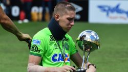 Brazilian Chapecoense goalkeeper Jackson Follmann, a survivor of the LaMia airplane crash in Colombia, holds the Copa Sudamericana trophy at the Arena Conda stadium in Chapeco, Santa Catarina state, in southern Brazil on January 21, 2017, before a friendly match against Palmeiras - Brazilian Champion 2016. 
Most of the members of the Chapocoense football team perished in a November 28, 2016 plane crash in Colombia. / AFP / NELSON ALMEIDA        (Photo credit should read NELSON ALMEIDA/AFP/Getty Images)