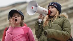 Young protesters shout on the National Mall in Washington, DC, for the Women's March on January 21, 2017. Hundreds of thousands of protesters spearheaded by women's rights groups demonstrated across the US to send a defiant message to US President Donald Trump. 