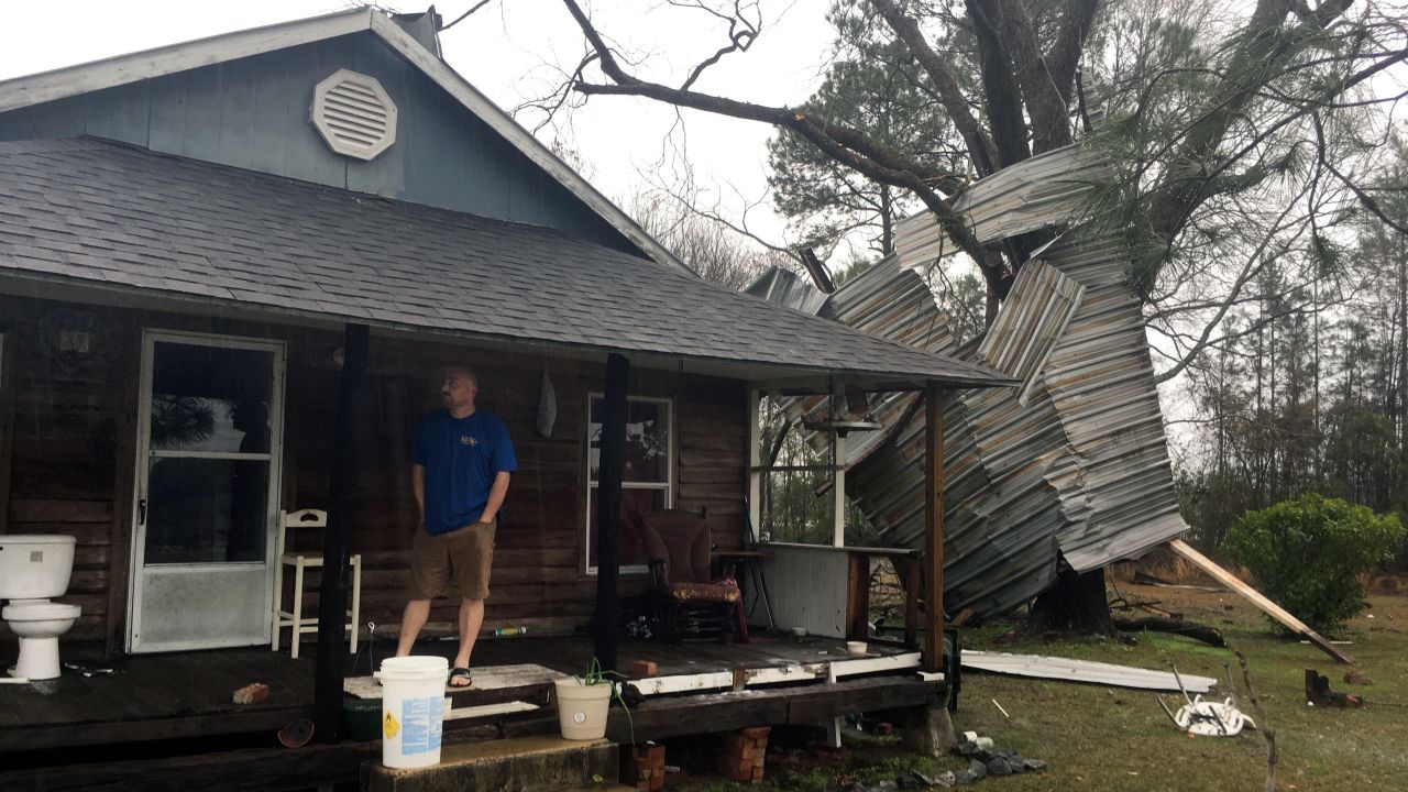 Jason Williams stands on the porch of a home belonging to his neighbor, Lamar Waters, in Appling County, Georgia, on January 22.